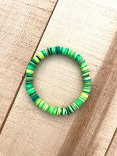 Green tone clay beads Green Heishi Beads Stretch Bracelet With Colorful Beads, Green Stretch Bracelet With Colorful Heishi Beads, Green Heishi Beads Stretch Bracelet, Green Round Beaded Bracelets For The Beach, Adjustable Green Beaded Bracelets With Wooden Beads, Trendy Green Heishi Beads Stretch Bracelet, Trendy Green Heishi Beads Bracelets, Green Clay Bracelet, Green Clay Bead Bracelet