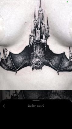 a woman's chest with a bat tattoo on it