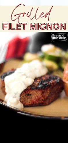 grilled filet migon with cream sauce on a brown plate next to vegetables