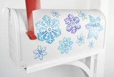 a white mailbox with blue and purple snowflakes on it