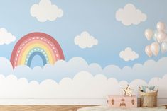 a child's room with a rainbow painted on the wall and balloons floating in the air