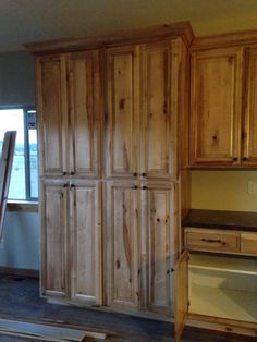 an unfinished kitchen with wooden cabinets in the process of being built and installed on the floor