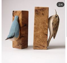 two wooden blocks with birds on them, one blue and the other brown in color