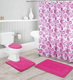 a bathroom with pink rugs and shower curtain