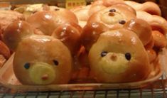 there are many donuts with teddy bears on them in the display case at the bakery