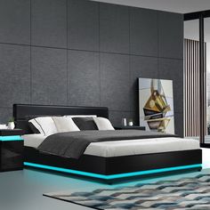 a modern bedroom with black and white furniture, blue lights on the bed frame and carpet