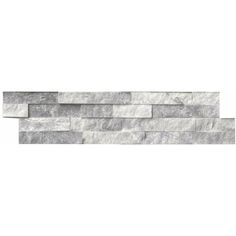 a white brick wall that is made out of grey marble bricks and has no mortars on