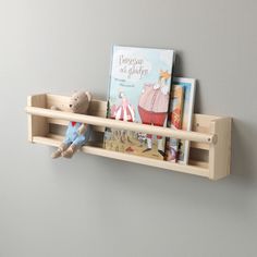 a wooden shelf with books and stuffed animals on it