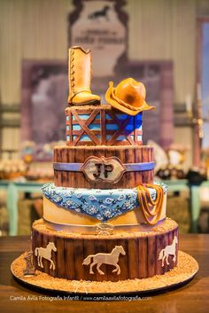 there is a cake made to look like a cowboy's hat and boots on top of a barrel