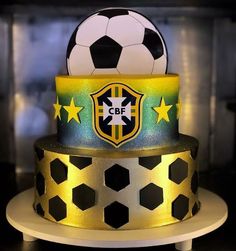 a three tiered cake with a soccer ball on top