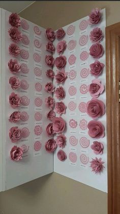 paper flowers are arranged on the wall in this room