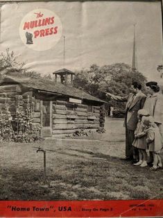 an old black and white photo of three people standing in front of a log cabin