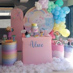 a table topped with lots of cake and balloons