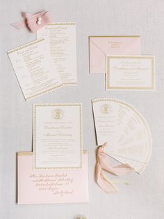 the wedding stationery is laid out and ready for guests to arrive