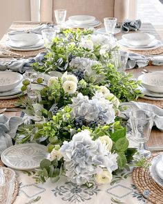 the table is set with white and green flowers