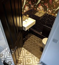 a bathroom with a sink, toilet and tiled floor