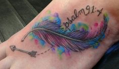 a colorful feather with the word dream written on it