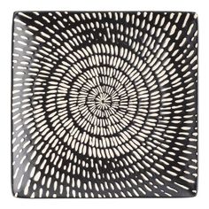 a black and white plate with an intricate design on it's surface, in the shape of a spiral