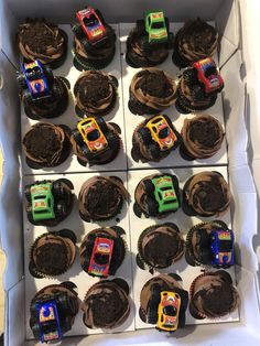 cupcakes decorated with trucks and dirt in a box