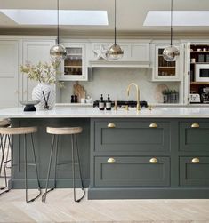 an image of a kitchen setting with grey cabinets and gold accents on the countertops