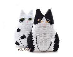 two crocheted black and white cats sitting next to each other