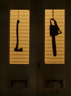 the silhouettes of two door handles are shown through blinds