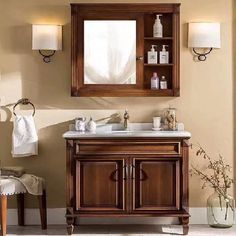 a bathroom with a sink, mirror and cabinet in it's centerpieces