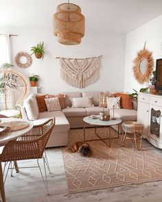 a living room filled with lots of furniture and decor on top of a wooden floor