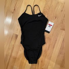 Nike Hydrastrong Solid Black One Piece Swim Suit. New With Tags And Hygiene Liner Still Intact. Size 28. Still Have Box. Nike Swim, Black One Piece, One Piece Swim, Black Swimsuit, Swim Suit, Women's Nike, Black Nikes, Solid Black, Womens Swim