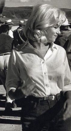 a black and white photo of a woman walking