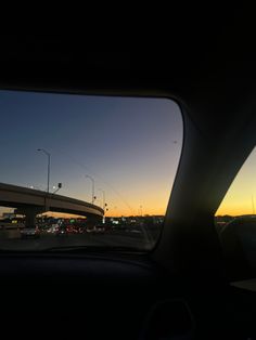 the sun is setting over an interstate highway