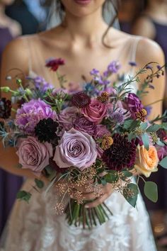 a woman holding a bouquet of flowers in her hands