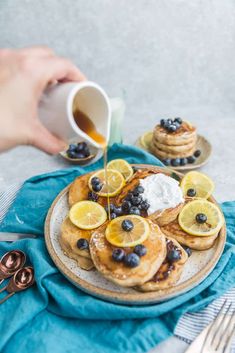 pancakes with blueberries and lemons on a plate