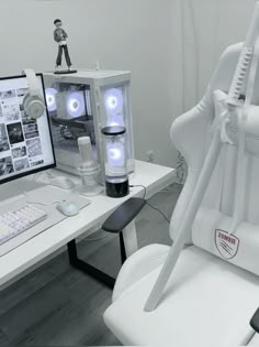 a white computer chair sitting in front of a monitor