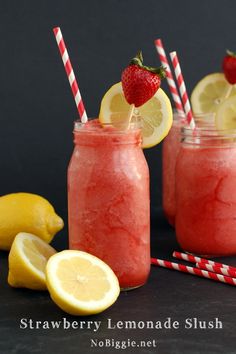 two mason jars filled with lemonade and strawberries