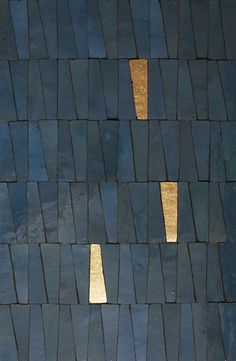 a black and white cat laying on top of a blue tiled floor