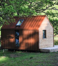 a small wooden house with a metal roof