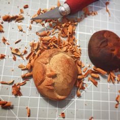 a muffin is sitting on a cutting board next to an orange peel and knife