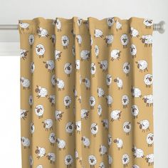 a yellow curtain with sheep on it