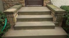 concrete steps lead up to the front door