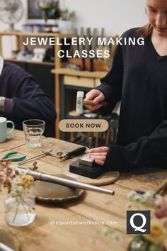 two women are working on glassware at a table with the words jewelry making classes above them