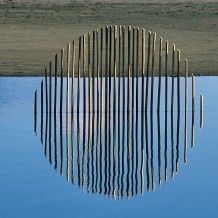 a large body of water with a fence in the middle