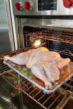 two raw chickens sit in an oven on racks