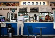 a man standing in front of a blue counter