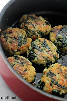 some food is cooking in a pan on the stove top and it looks like spinach patties