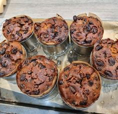 twelve chocolate muffins sitting on top of a metal pan