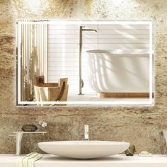 a bathroom sink sitting under a mirror next to a bath tub in a stone wall