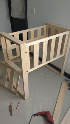 a wooden bunk bed frame being built with tools