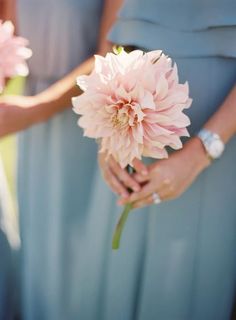 two bridesmaids holding pink flowers in their hands