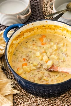 a blue pot filled with soup on top of a table